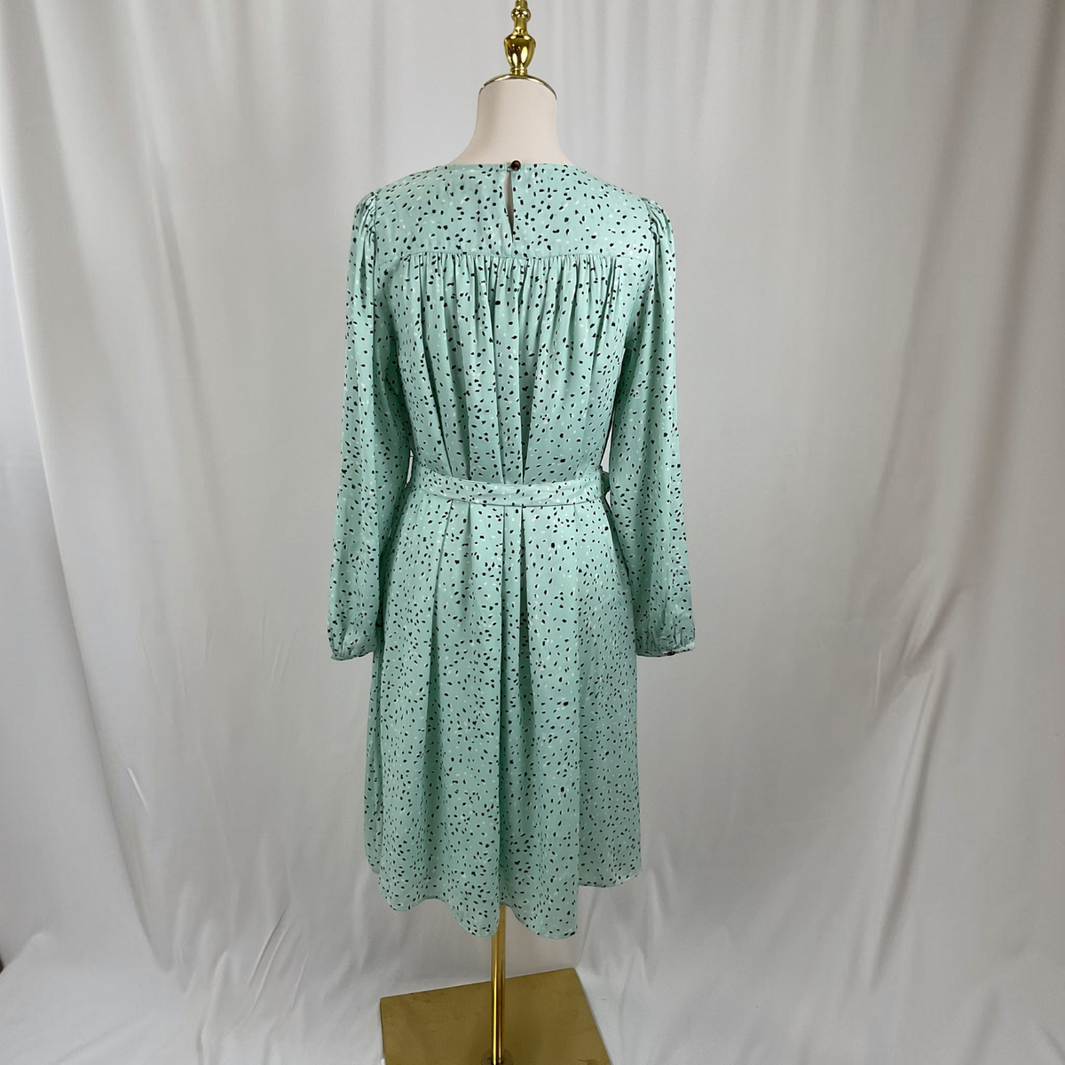 A scattered dot dress on a gray studio background