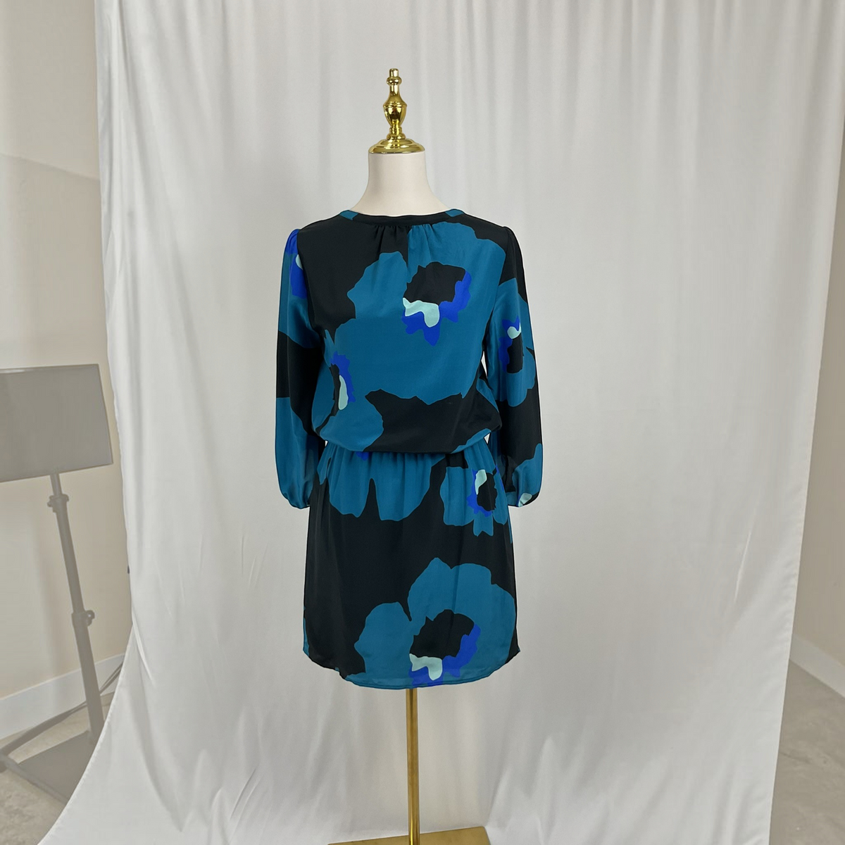 A floral print dress on a light gray studio background.