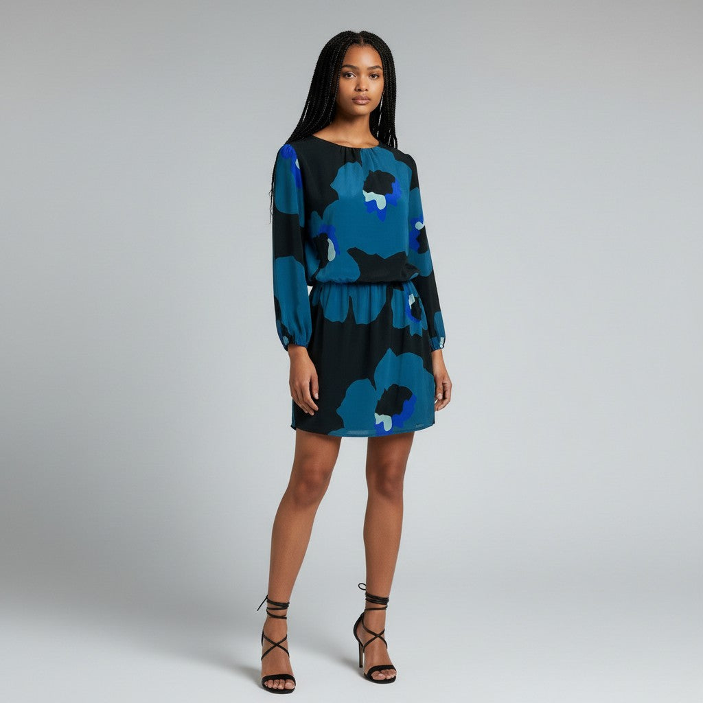 A woman wear black heels and A floral print dress on a light gray studio background.