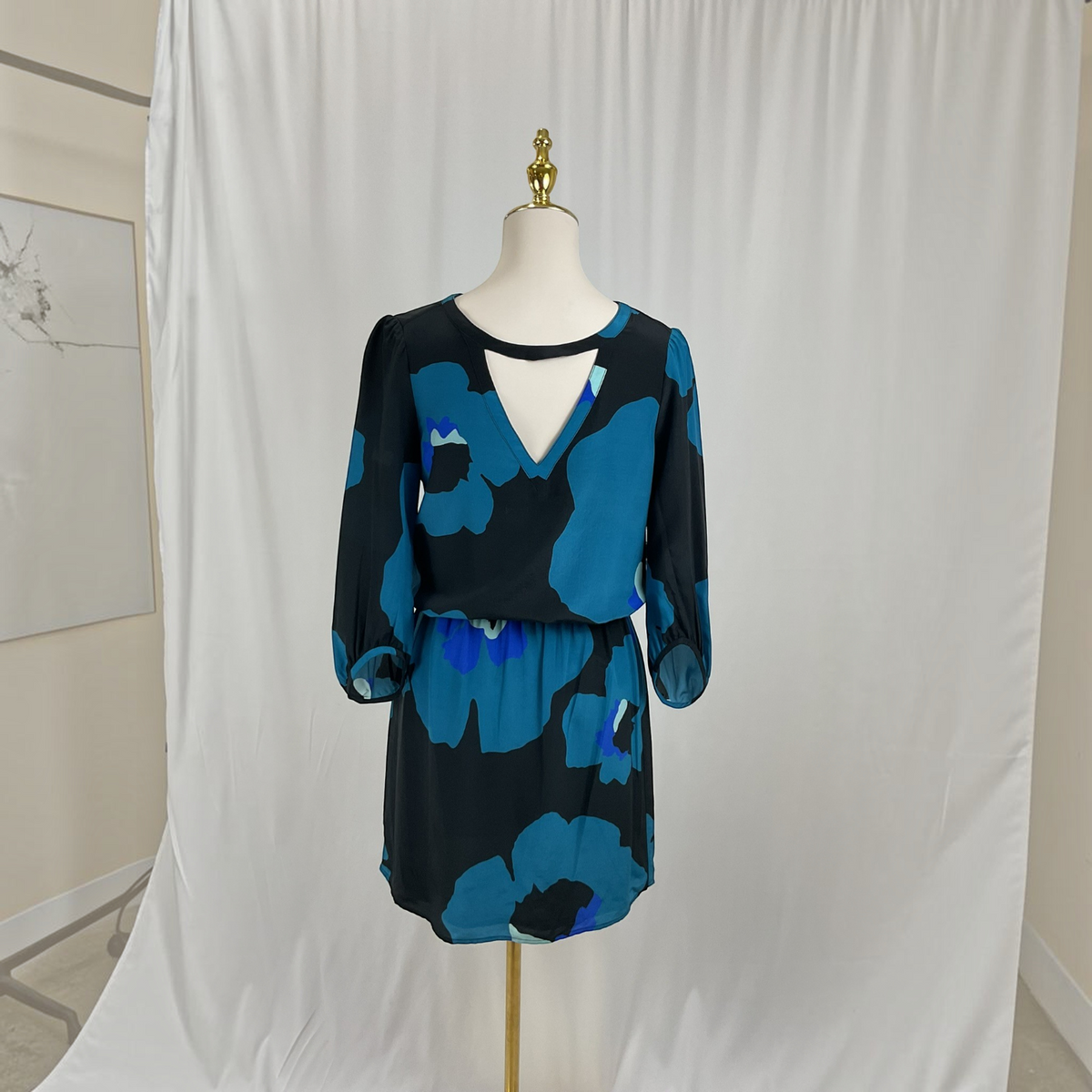 A floral print dress on a light gray studio background.