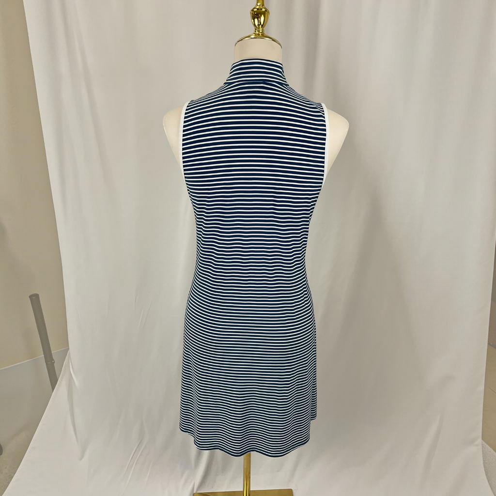 A sleeveless mock-neck knit dress with thin navy and white horizontal stripes, displayed on a cream mannequin torso with a gold stand against a white draped studio backdrop.