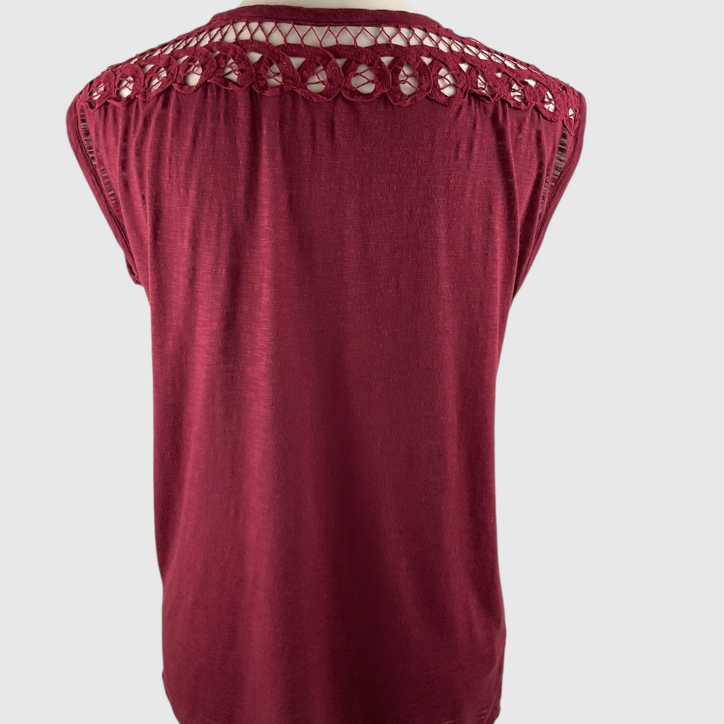 A sleeveless burgundy top with a decorative openwork lace neckline, shown against a light gray background.