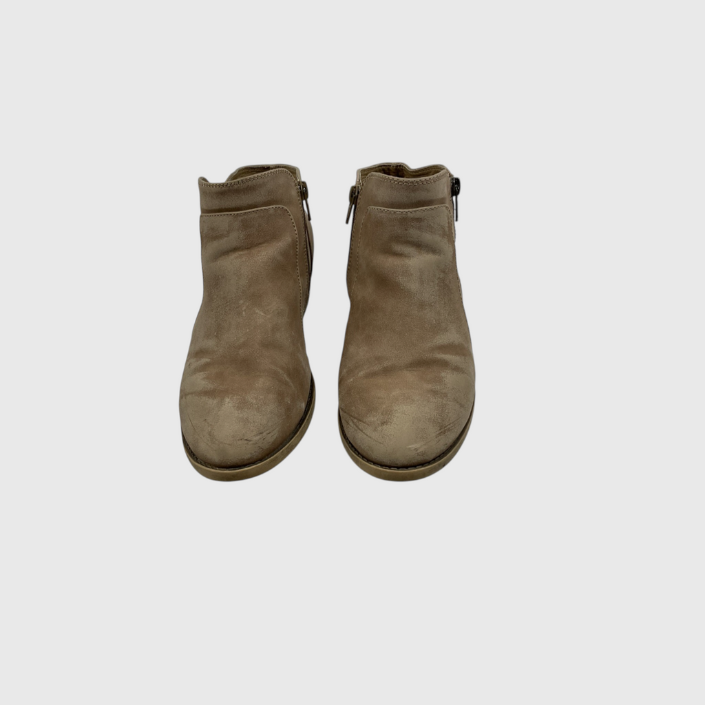 A pair of taupe-brown suede ankle boots with side zippers, shown from a top-down view on a light gray background.