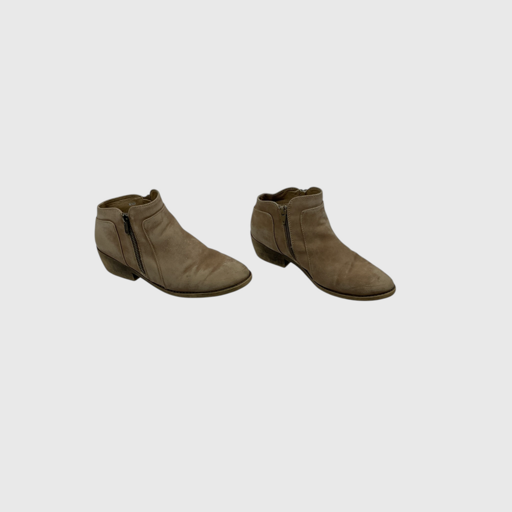 A pair of taupe-brown suede ankle boots with side zippers, shown from a three-quarters angle on a light gray background.
