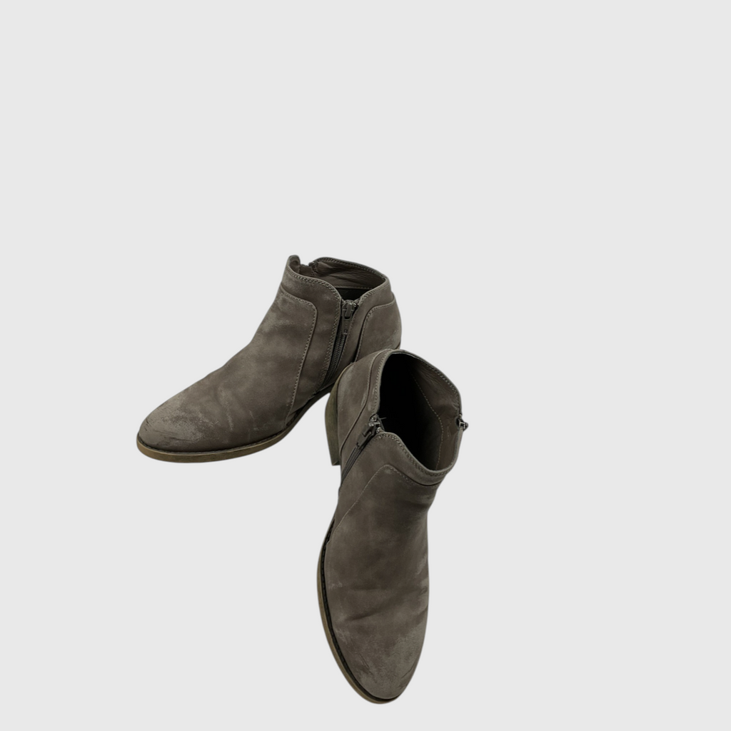 A pair of women's ankle boots in a distressed taupe-brown suede, shown from a high-angle perspective against a light gray background.