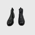 A pair of black leather ankle boots with side zippers and pull tabs, shown from a front-facing perspective on a light gray background.