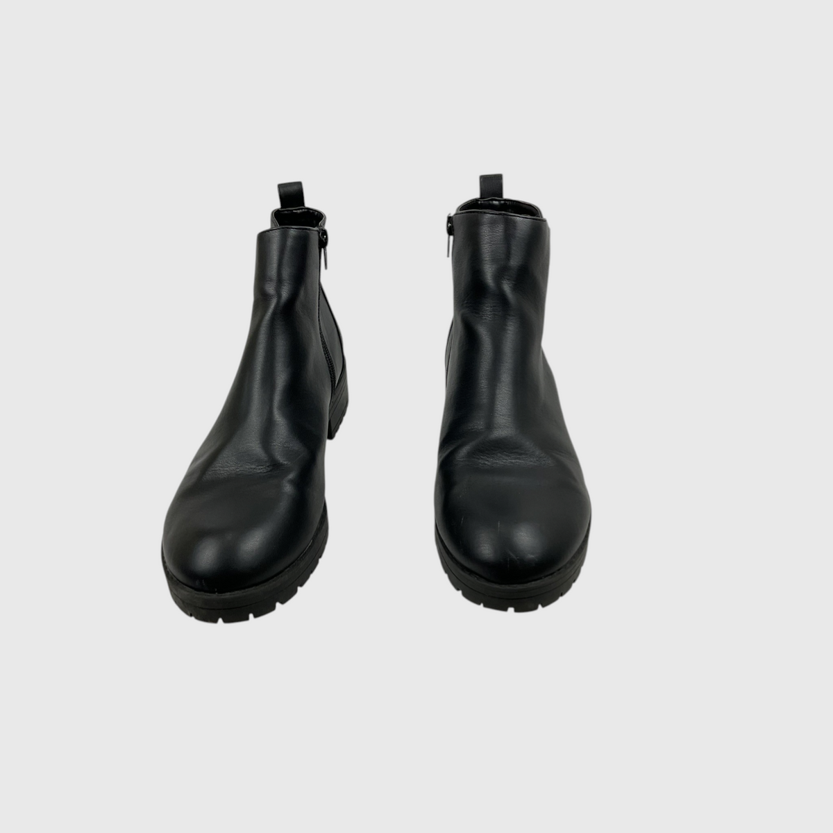 A pair of black leather ankle boots with side zippers and pull tabs, shown from a front-facing perspective on a light gray background.