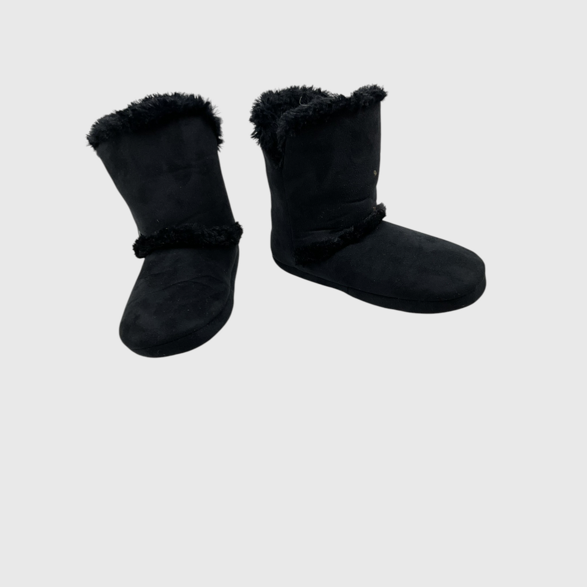 A pair of black slip-on slippers with plush faux-fur trim at the top and a matching band around the middle, shown on a light gray background.