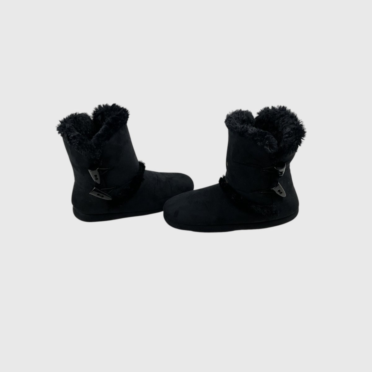 A pair of black mid-calf boots with plush faux-fur trim at the collar and decorative strap details on the sides, shown against a light gray background.