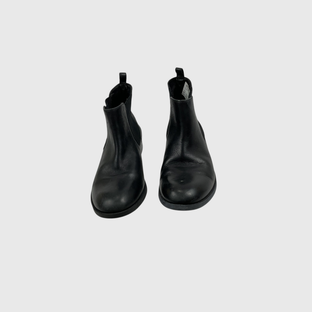 A pair of black leather Chelsea boots shown from a top-down view on a light gray background.