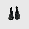 A pair of black leather Chelsea boots shown from a top-down view on a light gray background.
