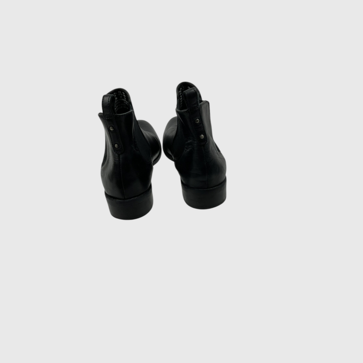 A pair of black leather ankle boots shown from the back on a light gray background.