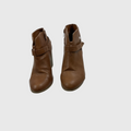 A pair of women's brown ankle boots with side zippers and a decorative strap detail on the front, shown against a plain light gray background.