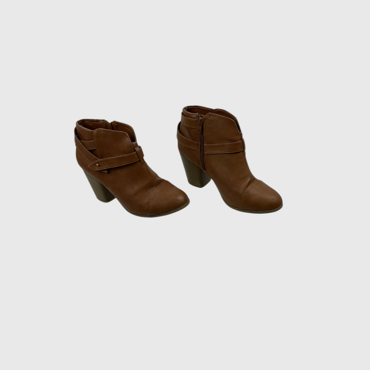 A pair of women's brown faux-leather ankle boots with a block heel, side zipper, and decorative strap detail on the front, shown against a light gray background.