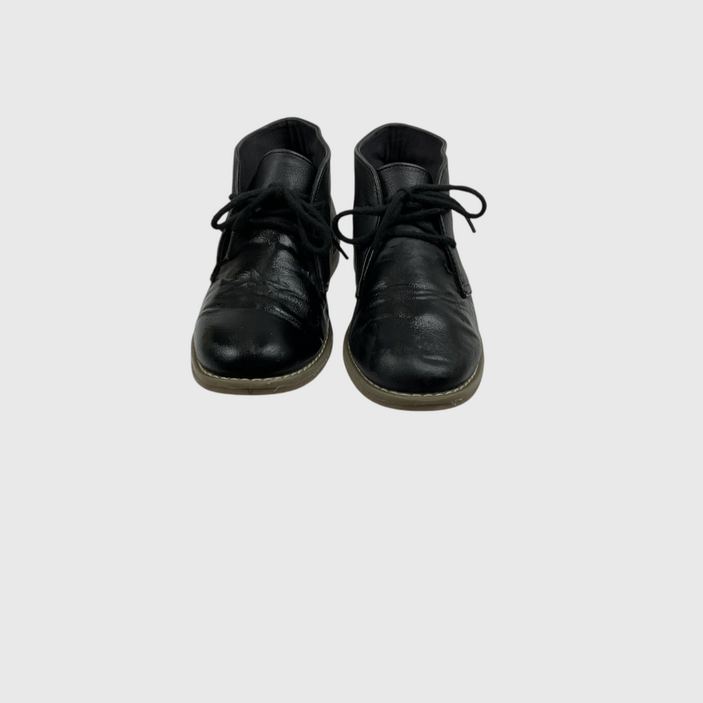 A pair of black leather lace-up ankle boots with black laces and light tan soles, photographed from the front against a solid light gray background.