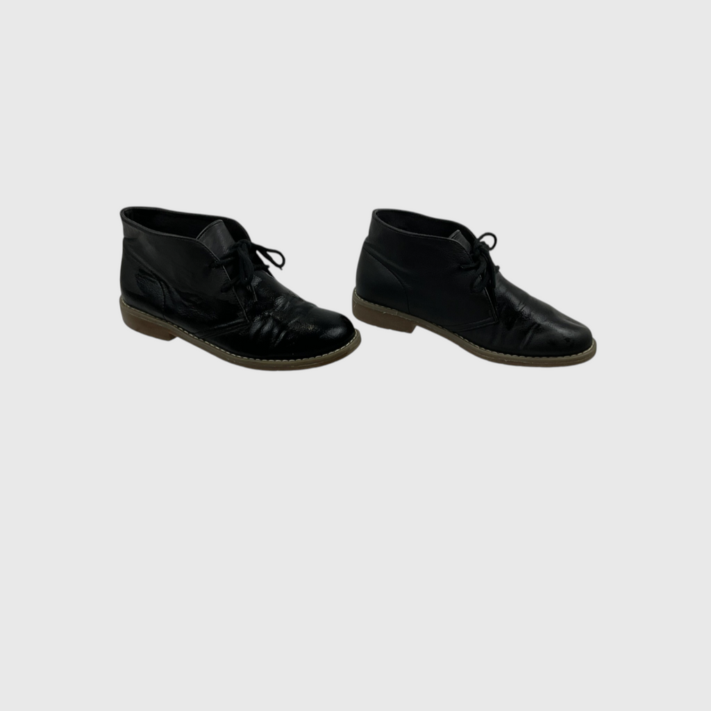 A pair of black leather lace-up ankle boots with brown soles, shown from the side against a light gray background.