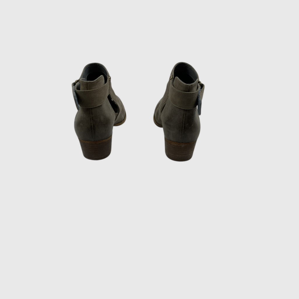 A pair of women's ankle boots shown from the back, featuring a dark olive green leather upper with a side cutout and a brown stacked heel, set against a plain light gray background.